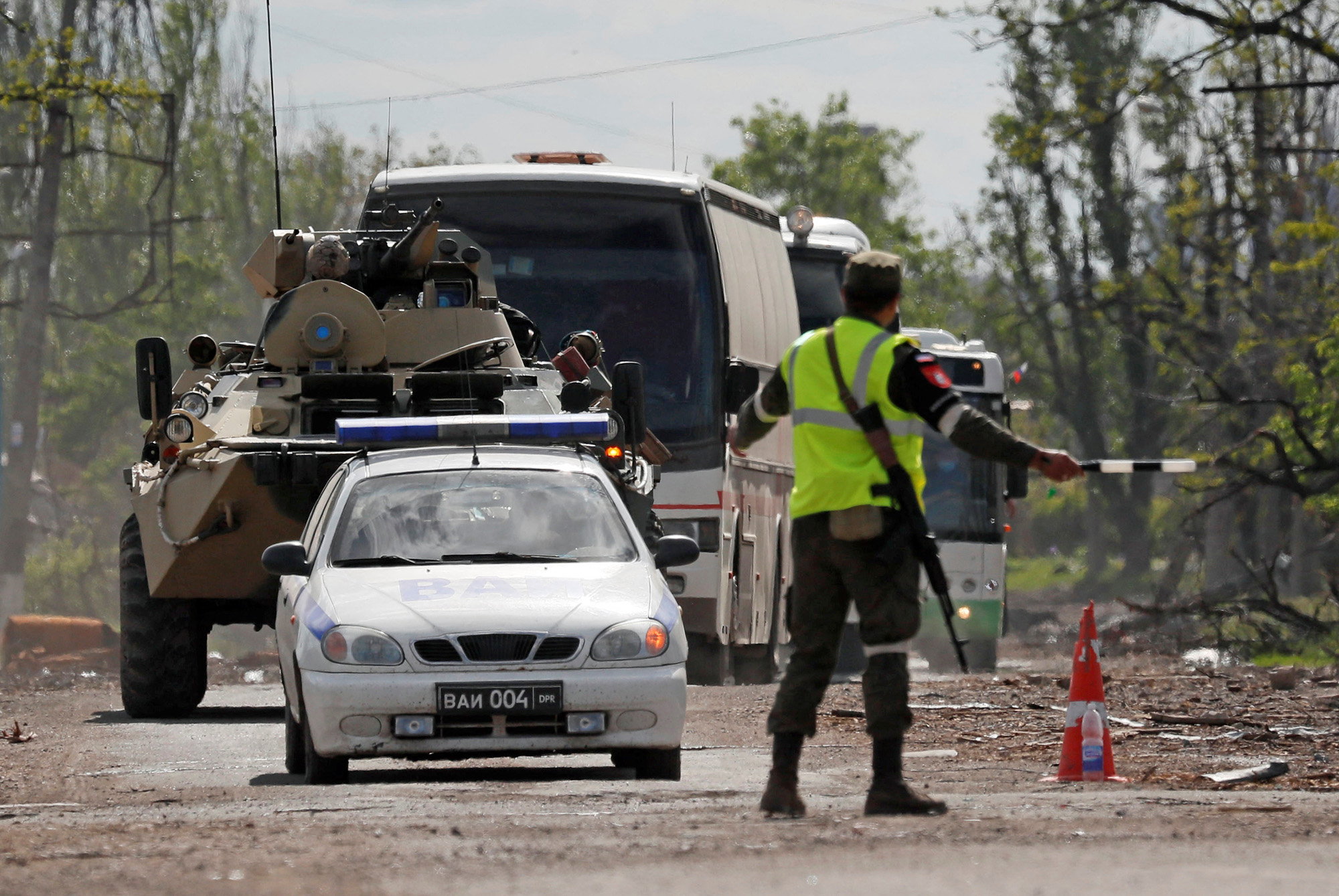 Buses carrying members of Ukrainian forces who have surrendered from the Azovstal steel works in Mariupol, Ukraine, drive away under escort of the pro-Russian military on May 17.