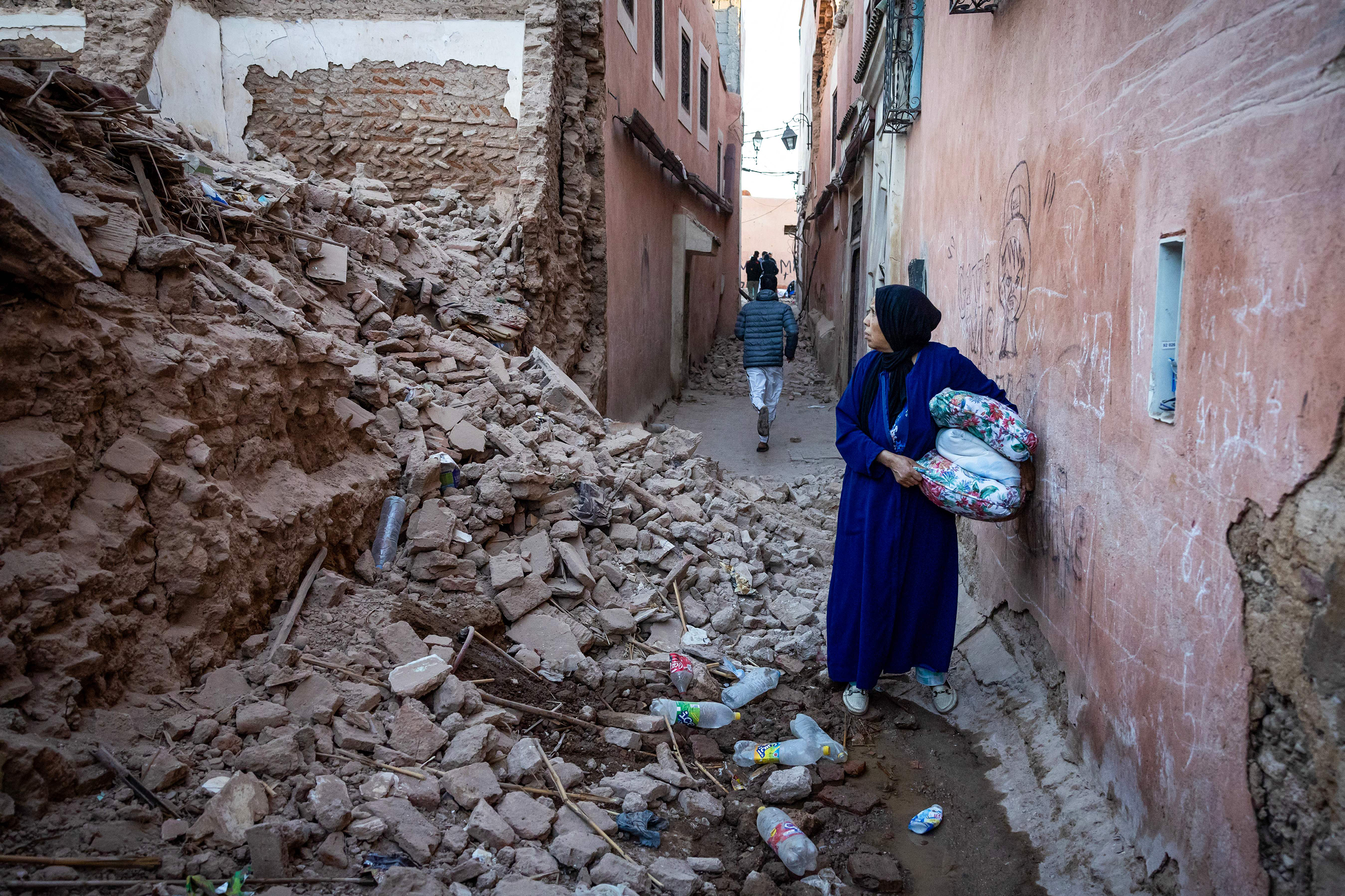 A woman looks at the rubble of a building in the earthquake-damaged old city in Marrakesh on September 9.