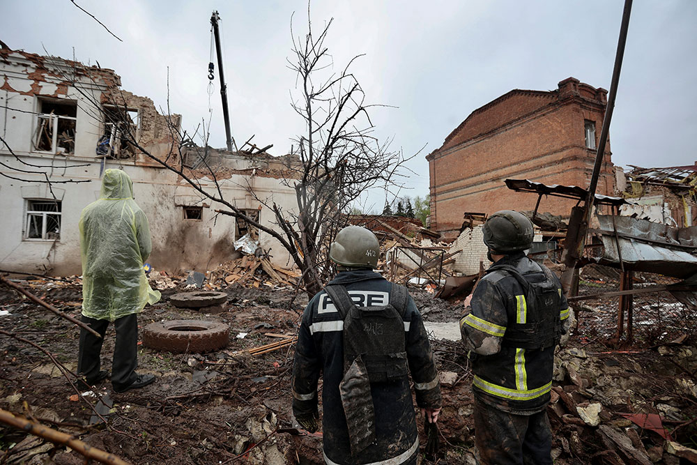 Rescuers are seen at the site of a museum heavily damaged by a Russian missile strike in Kupyansk, Ukraine on Tuesday, April 25. 