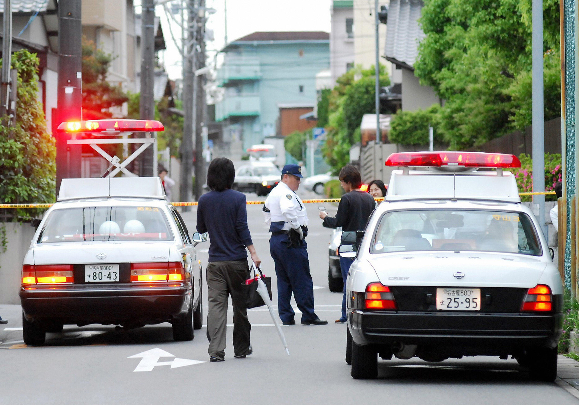 A policeman stands outside of a residential area of Nagakute town in Aichi prefecture, near Nagoya on May 17, 2007 after a man fired a gun.