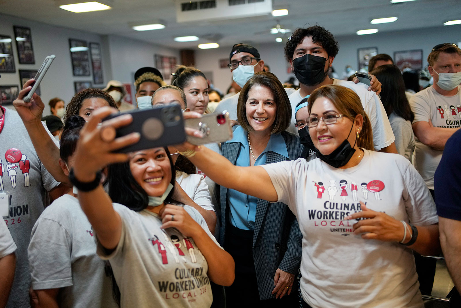 Catherine Cortez Masto, center, poses for photos with members of a culinary union on October 8 in Las Vegas. 