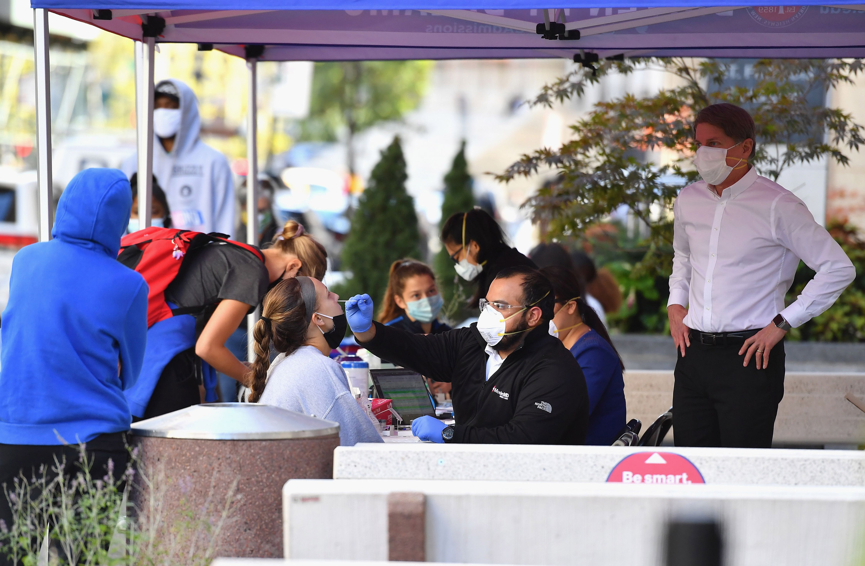 A medical worker takes a nasal swab sample to test for COVID-19 at the Brooklyn Health Medical Alliance urgent care pop up testing site on October 8 in New York City.