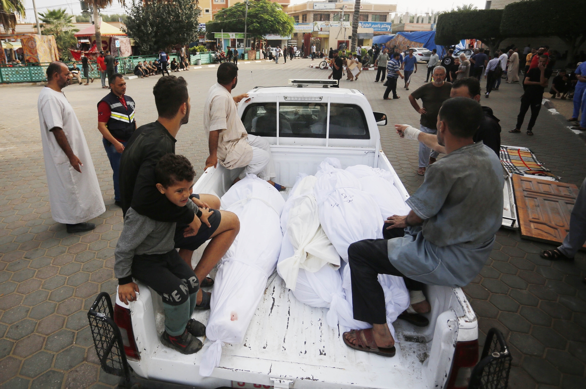 People take the bodies out of the mortuary of Al Aqsa Martyrs Hospital to bury them in Deir al-Balah, Gaza, on Saturday.
