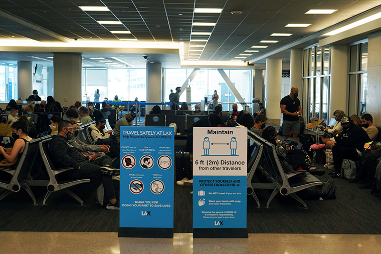 A face mask and social distance advisory sign at the Los Angeles International Airport, Friday, April 9.
