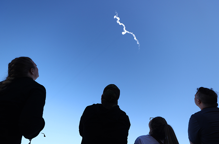 People watch as Blue Origin’s New Shepard flies toward space carrying 90-year-old Star Trek actor William Shatner and three other civilians on October 13, 2021 near Van Horn, Texas. 
