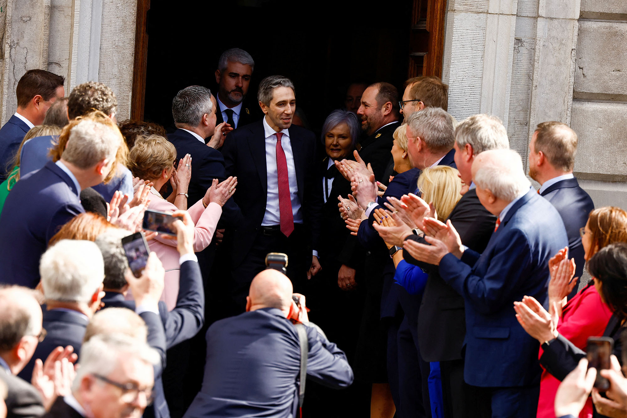 People applaud as Simon Harris looks on after receiving a majority parliamentary vote to become the next Taoiseach of Ireland, in Dublin, Ireland, on April 9.