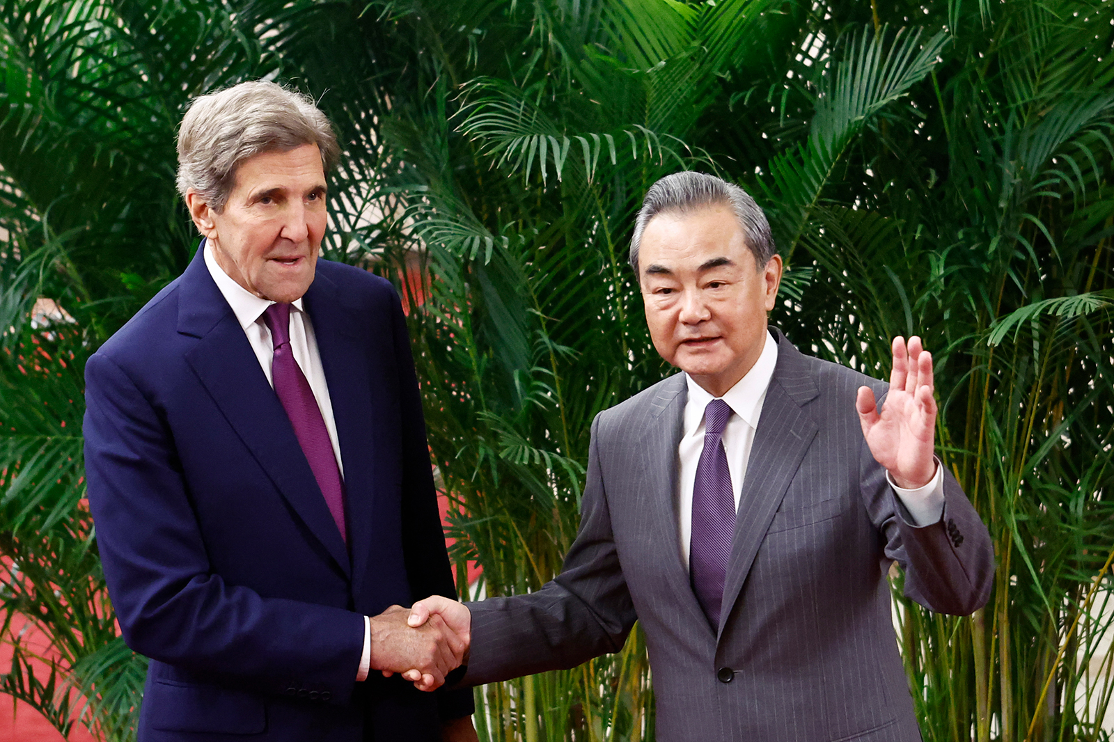 John Kerry is greeted by Wang Yi before a meeting in Beijing on July 18.