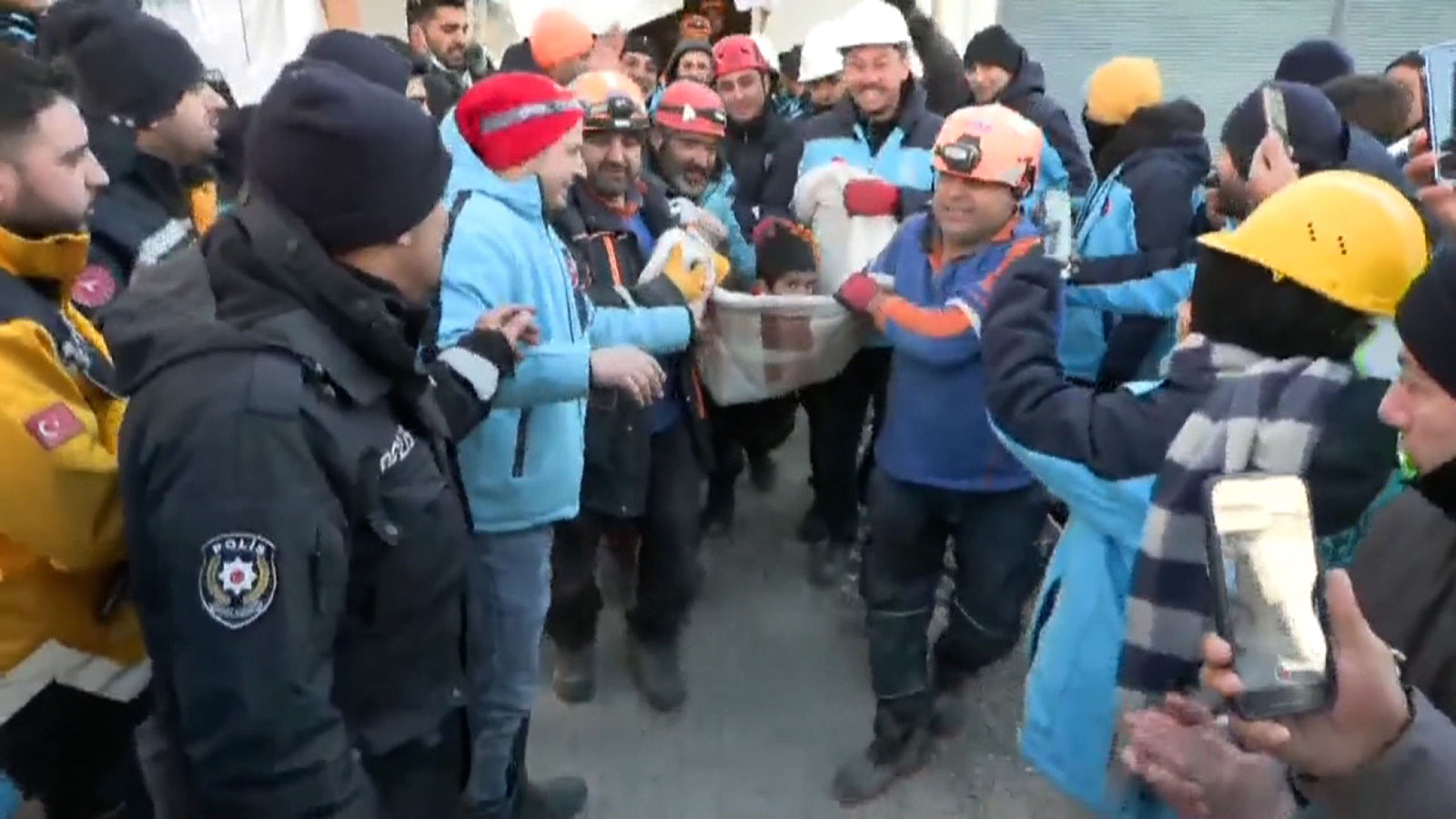 A boy is carried from the rubble in a blanket 78 hours after the earthquake hit in Kahramanmaras, Turkey.