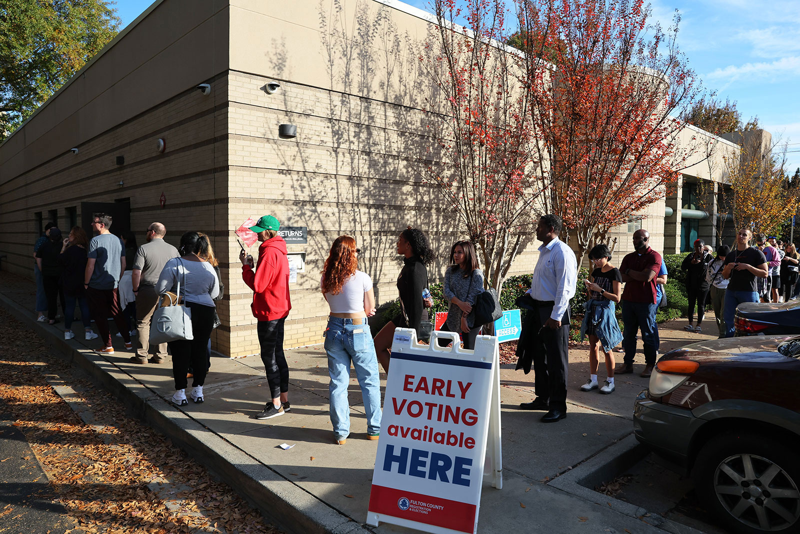 People wait in line on the last day of in-person early voting at a public library in Atlanta on November 4. 