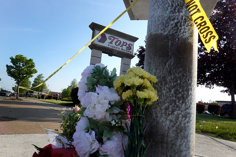 Flowers are left at a makeshift memorial outside of Tops market on May 15, 2022 in Buffalo, New York.