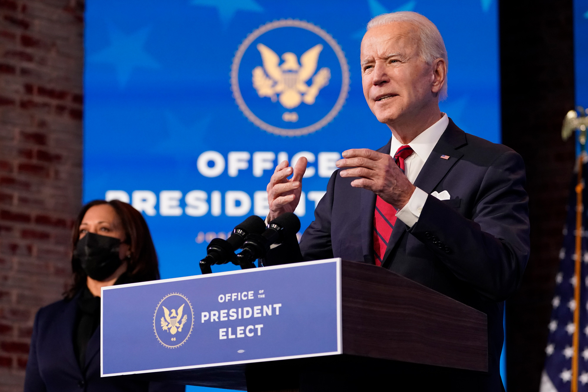 Vice President-elect Kamala Harris listens as President-elect Joe Biden speaks during an event at The Queen theater on January 15 in Wilmington, Delaware.