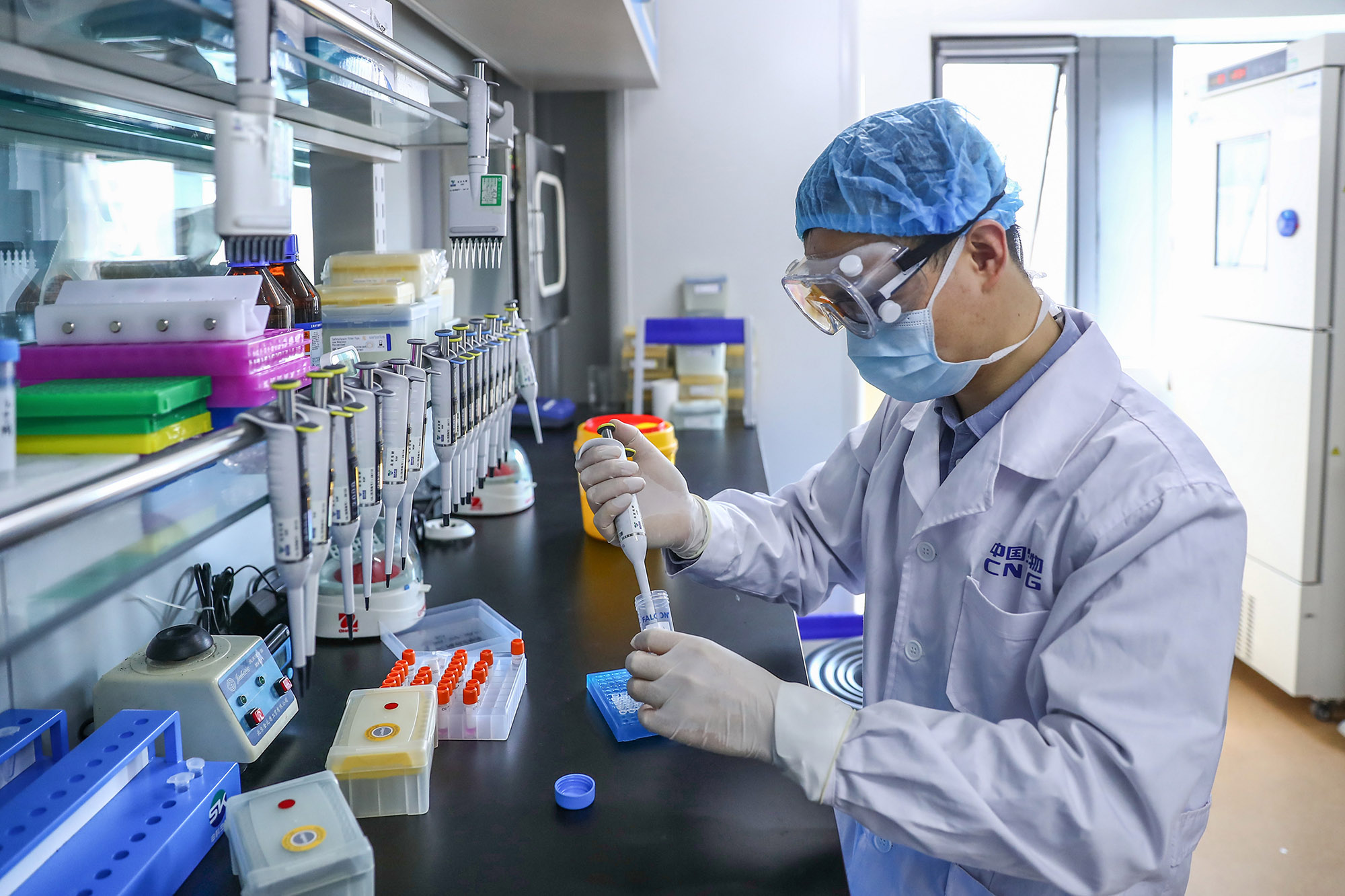 A staff member tests samples of the Covid-19 inactivated vaccine at a China National Pharmaceutical Group plant in Beijing, on April 11, 2020. 