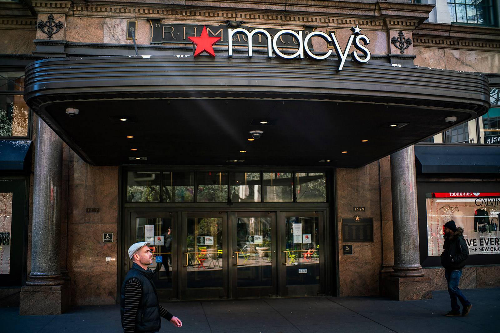 People walk by a closed Macy's store in New York on March 24.