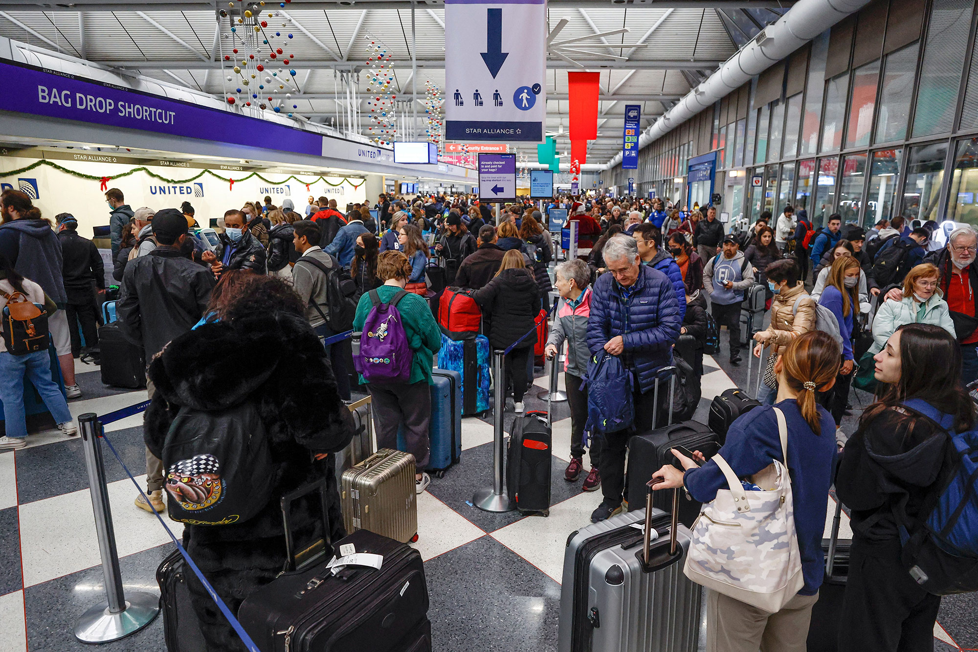Travelers arrive for their flights at O'Hare International Airport on Thursday, December 22, in Chicago. 
