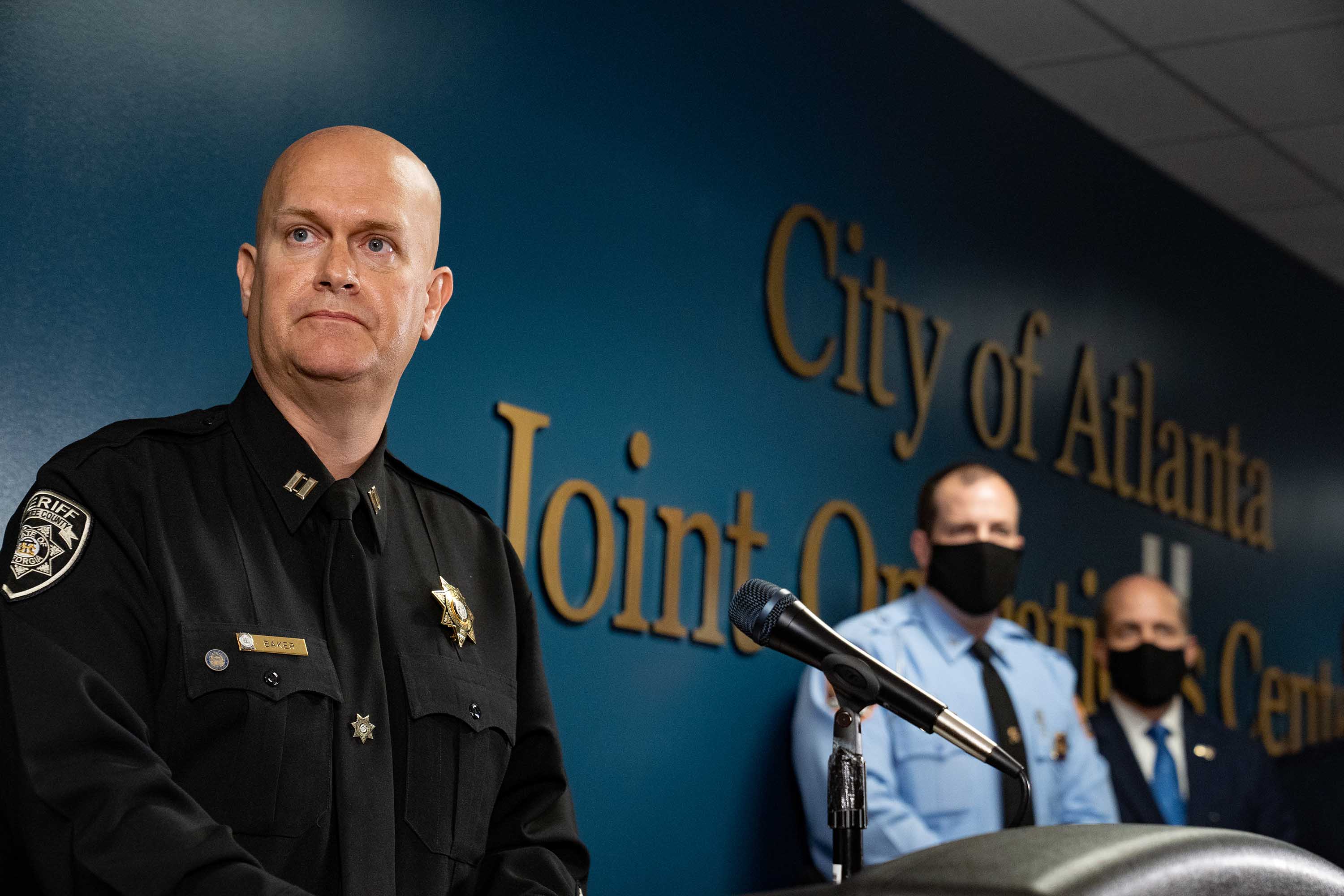 Captain Jay Baker, left, speaks at a press conference on March 17, 2021 in Atlanta, Georgia. Suspect Robert Aaron Long, 21, was arrested after a series of shootings at three Atlanta-area spas left eight people dead on Tuesday night, including six Asian women.(Photo by Megan Varner/Getty Images)