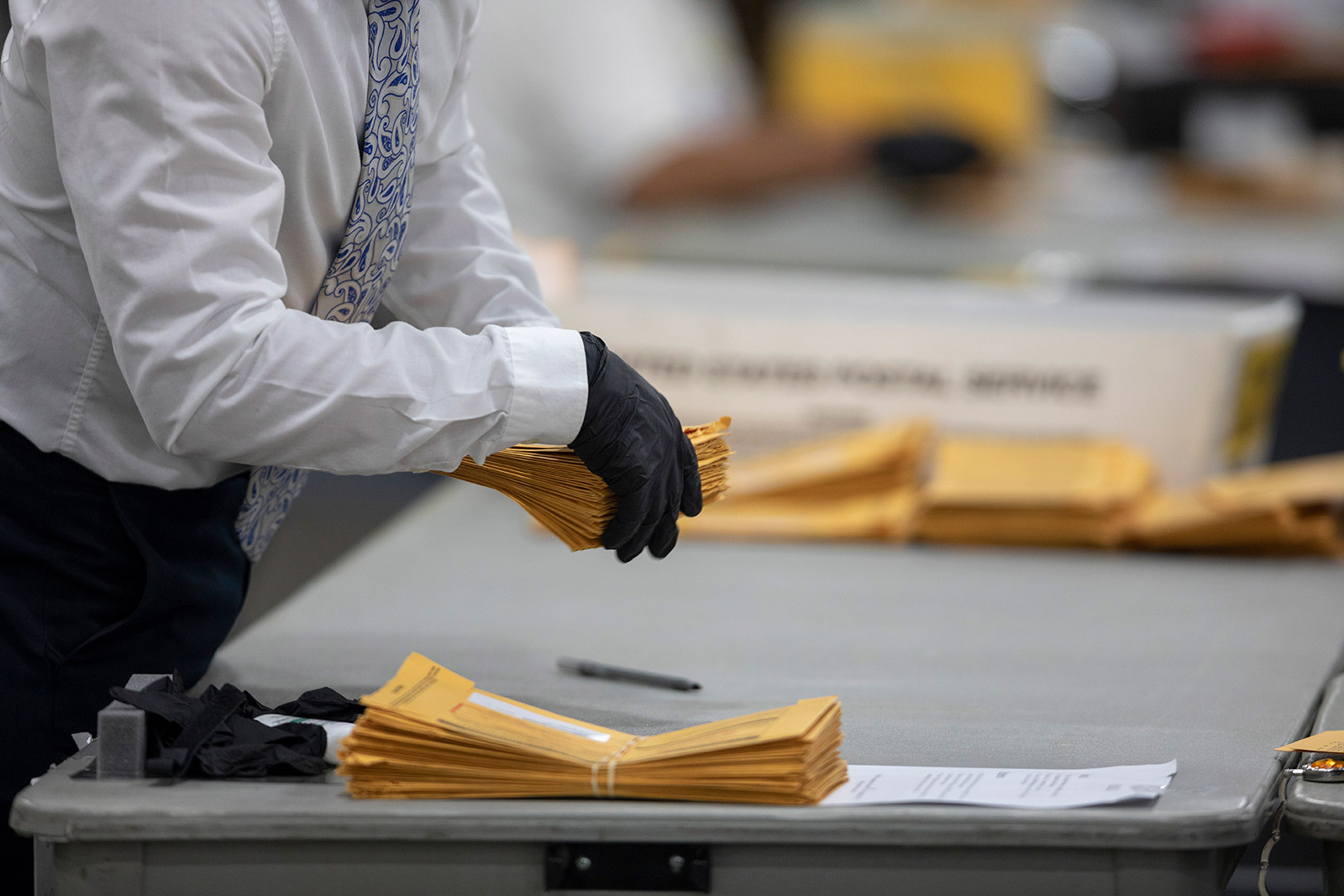 A worker sorts through absentee ballots in Detroit on November 4.