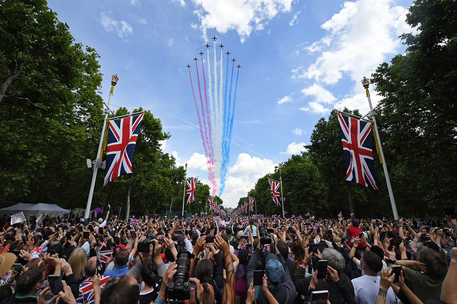 Spectators watch the RAF flypast on The Mall after the Trooping the Colour parade on June 2 in London.
