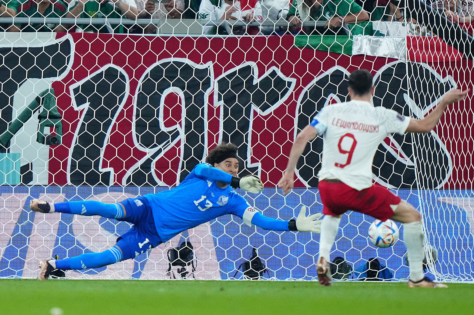 Mexico goalkeeper Guillermo Ochoa blocks the penalty shot of Poland forward Robert Lewandowski on November 22. 