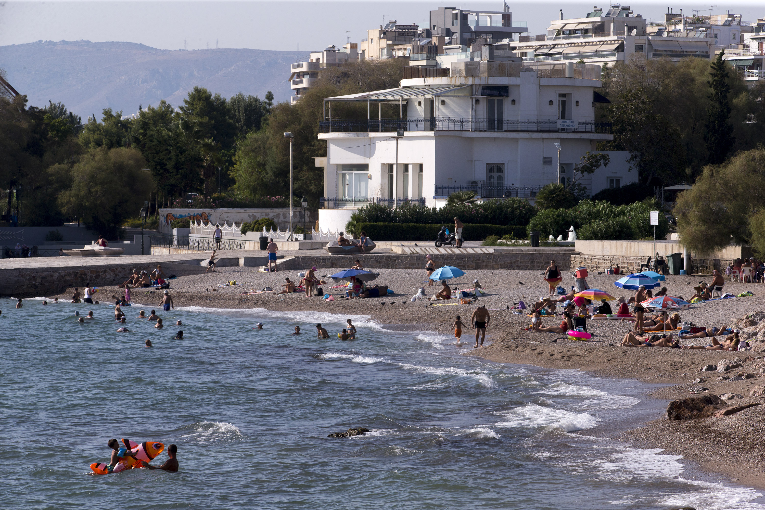 People visit a beach in Athens, Greece, on September 1.