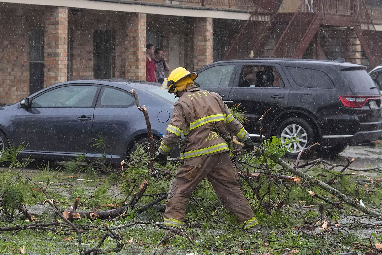 A firefighter clears debris in the aftermath of severe storms that swept through the region in Slidell, Louisiana, on Wednesday.