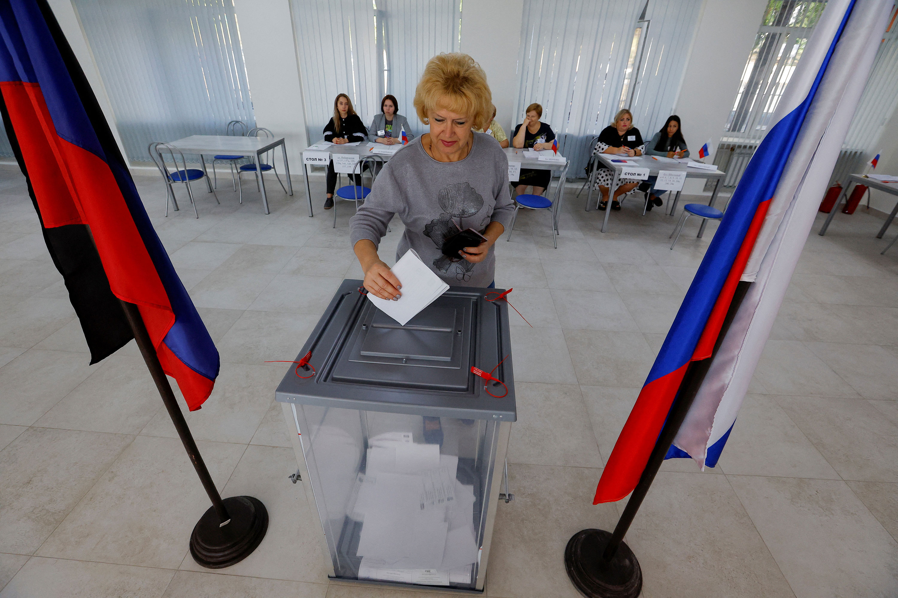 A voter casts a ballot at a polling station during local elections held by Russian-installed authorities in Donetsk, Russian-controlled Ukraine, on September 8. 