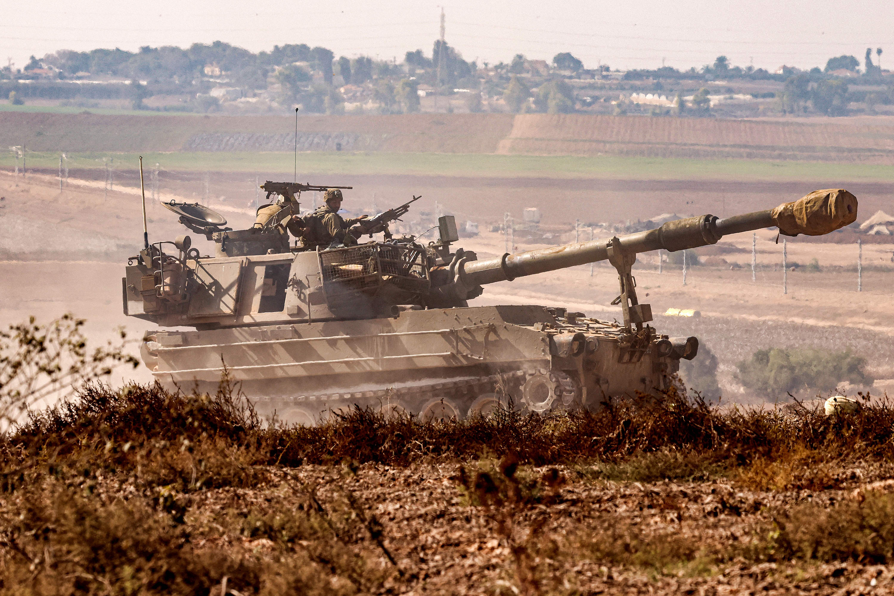 An Israeli army artillery howitzer moves at a position near the border with the Gaza Strip in southern Israel on November 3.