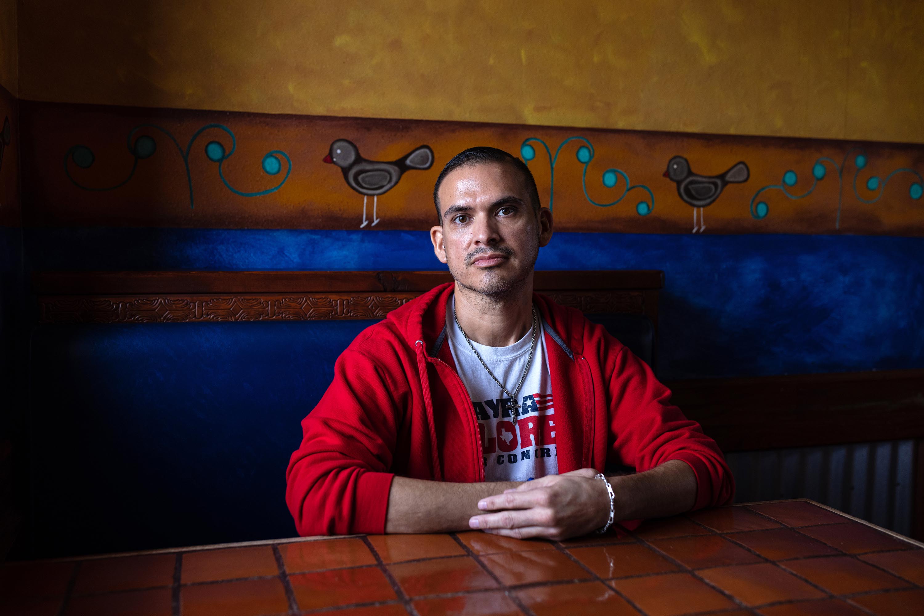 Eddie Gonzales, a volunteer campaigning for Mayra Flores, Republican candidate for Texas' 34th Congressional District, sits for a portrait at El Pato Mexican Food, the location of a blockwalk kick-off event, in Brownsville, Texas, on February 19, 2022.