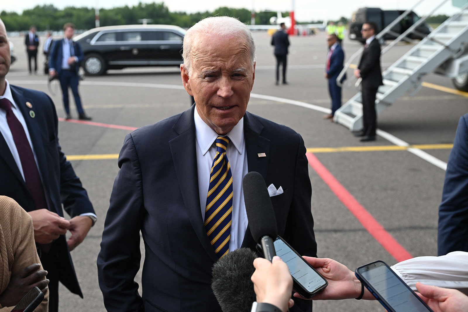 US President Joe Biden answers questions from the press prior to boarding at the Vilnius International Airport in Vilnius, Lithuania, on Wednesday.