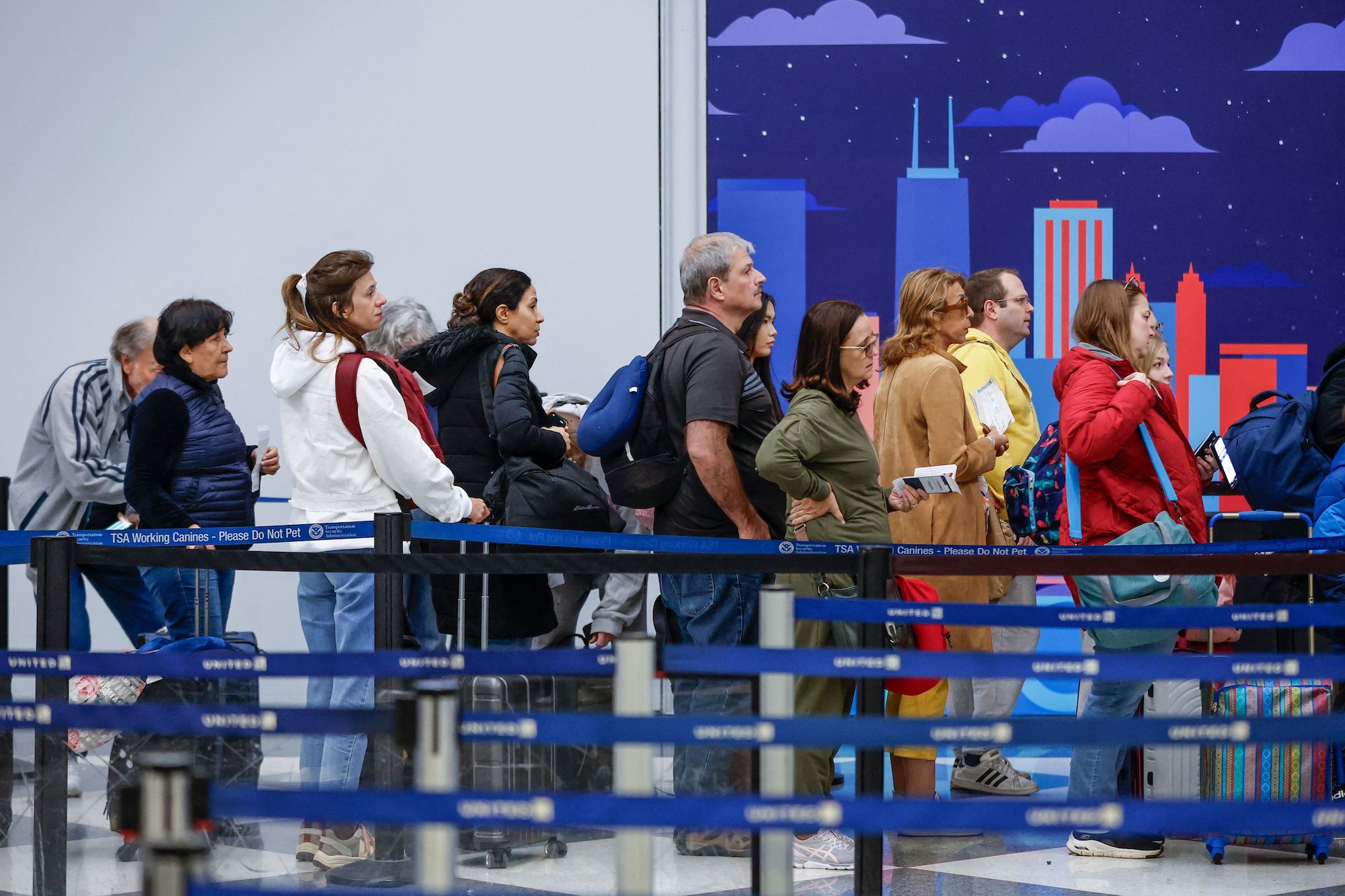 Travelers wait at a security checkpoint at O'Hare International Airport in Chicago on Tuesday.
