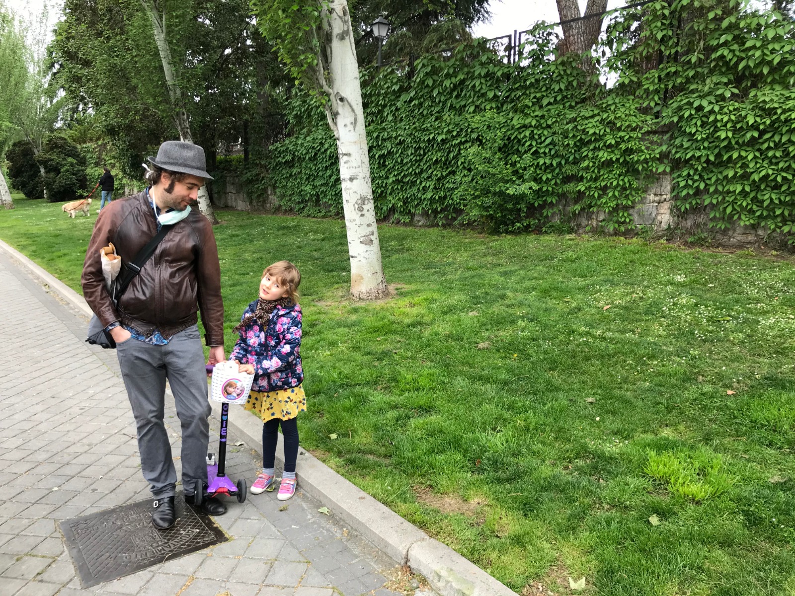 One man and his daughter walk outside their home in Madrid on Sunday.