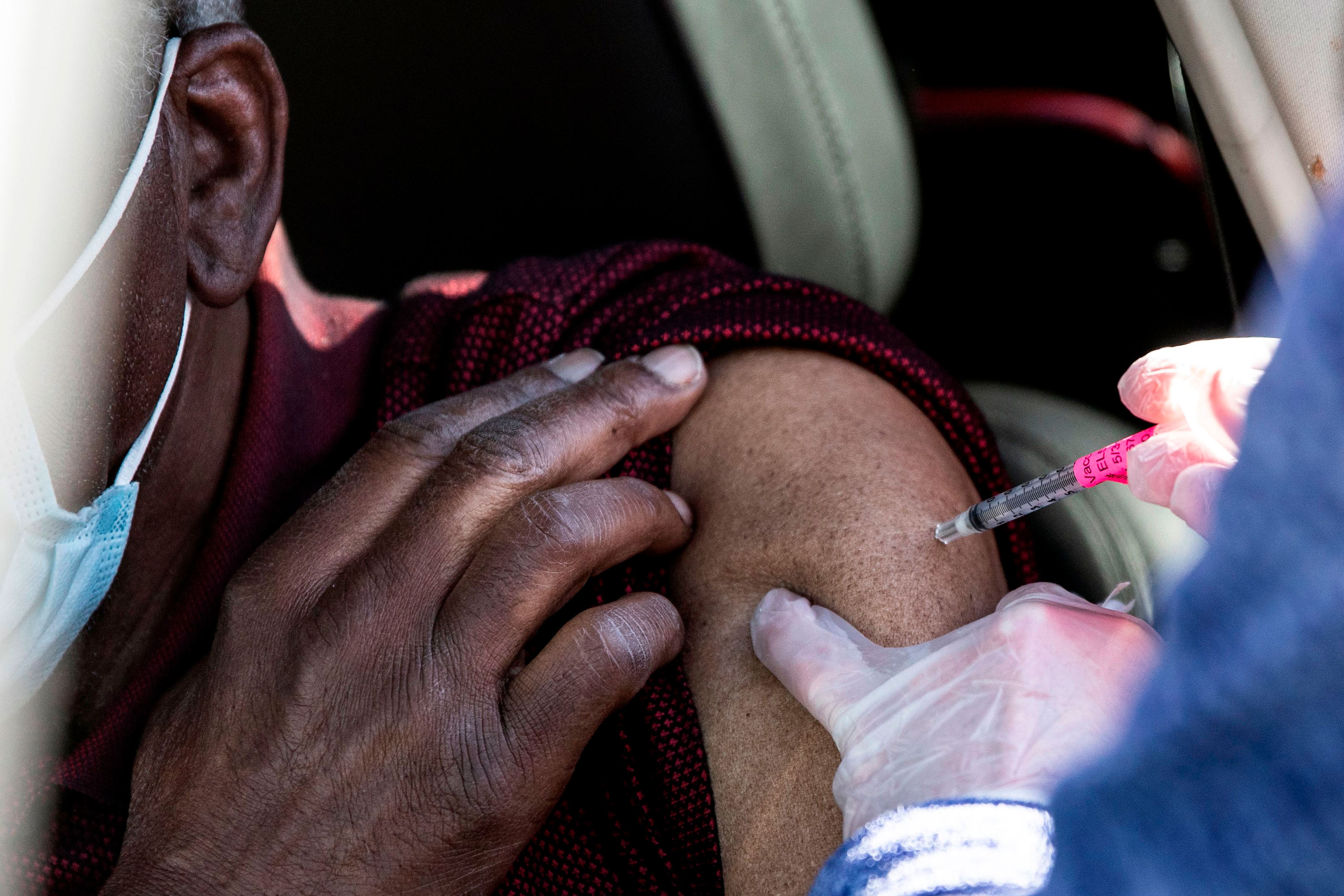 A man gets his first dose of the Covid-19 vaccine administered at Coors Field baseball stadium on January 30 in Denver.