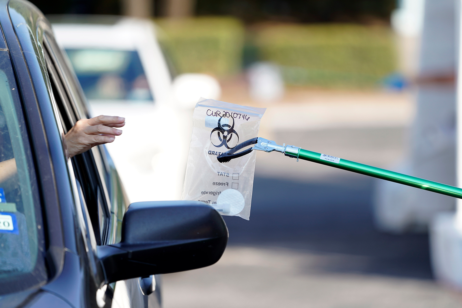 A sample is collected at a Covid-19 testing site at Minute Maid Park in Houston, on August, 8.