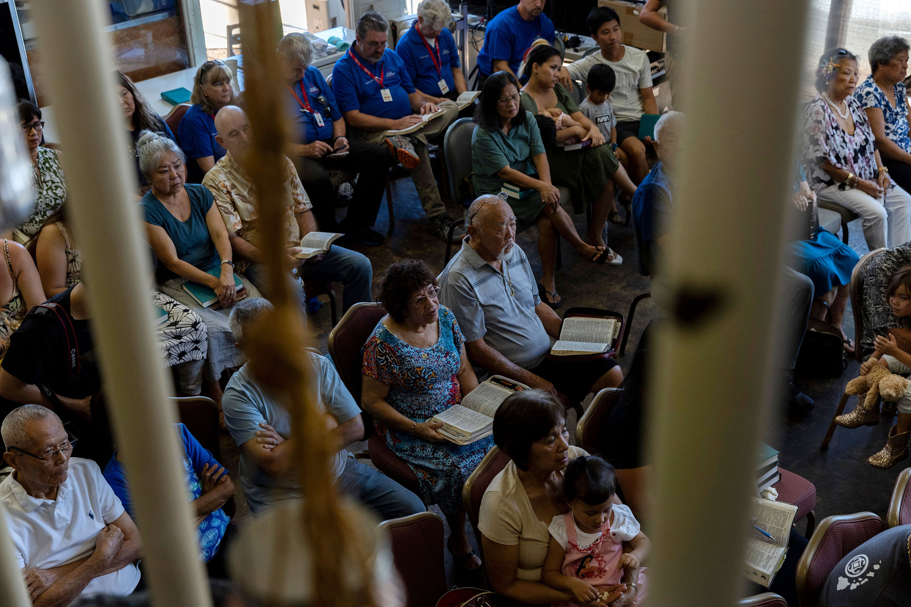 Displaced Lahaina residents attend a memorial service at Maui Coffee Attic in Wailuku, Hawaii, on Saturday. The cafe hosted Grace Baptist Church's Sunday service after the church was destroyed in the fire. 