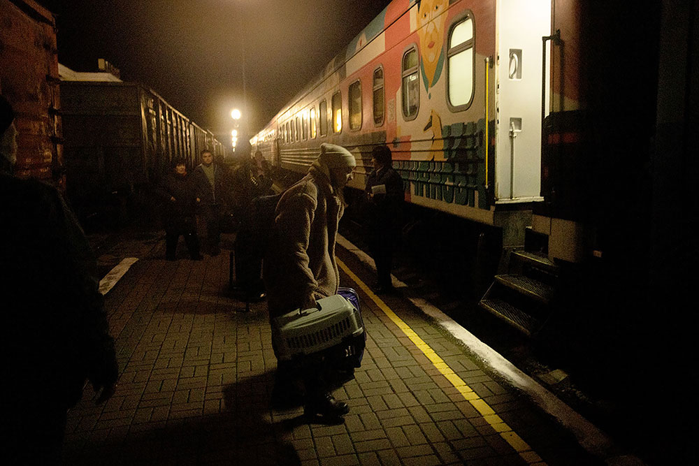 A resident boards an evacuation train on Monday, November 21, in Kherson, Ukraine. 