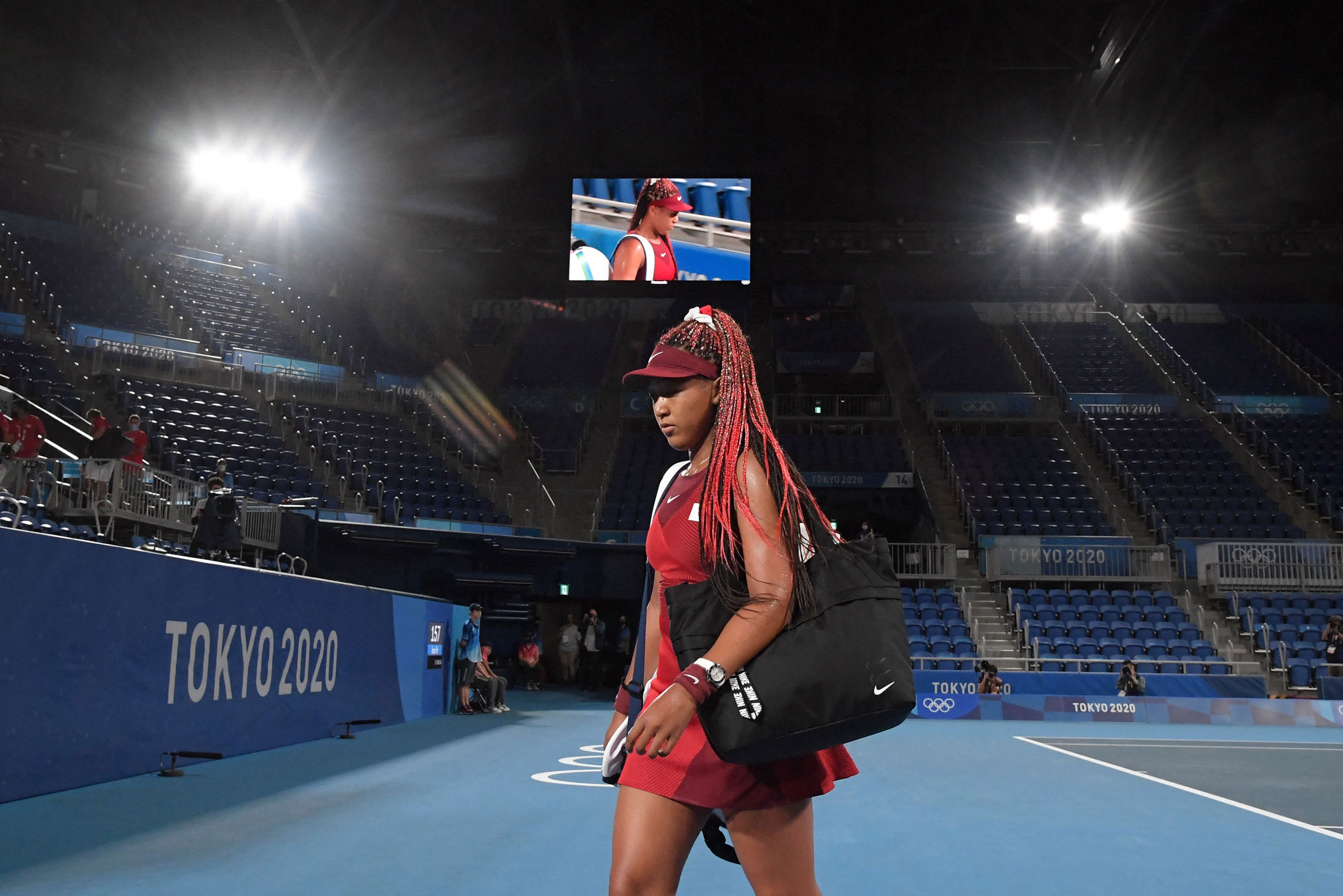Japan's Naomi Osaka leaves the court after being defeated by Czech Republic's Marketa Vondrousova on July 27.