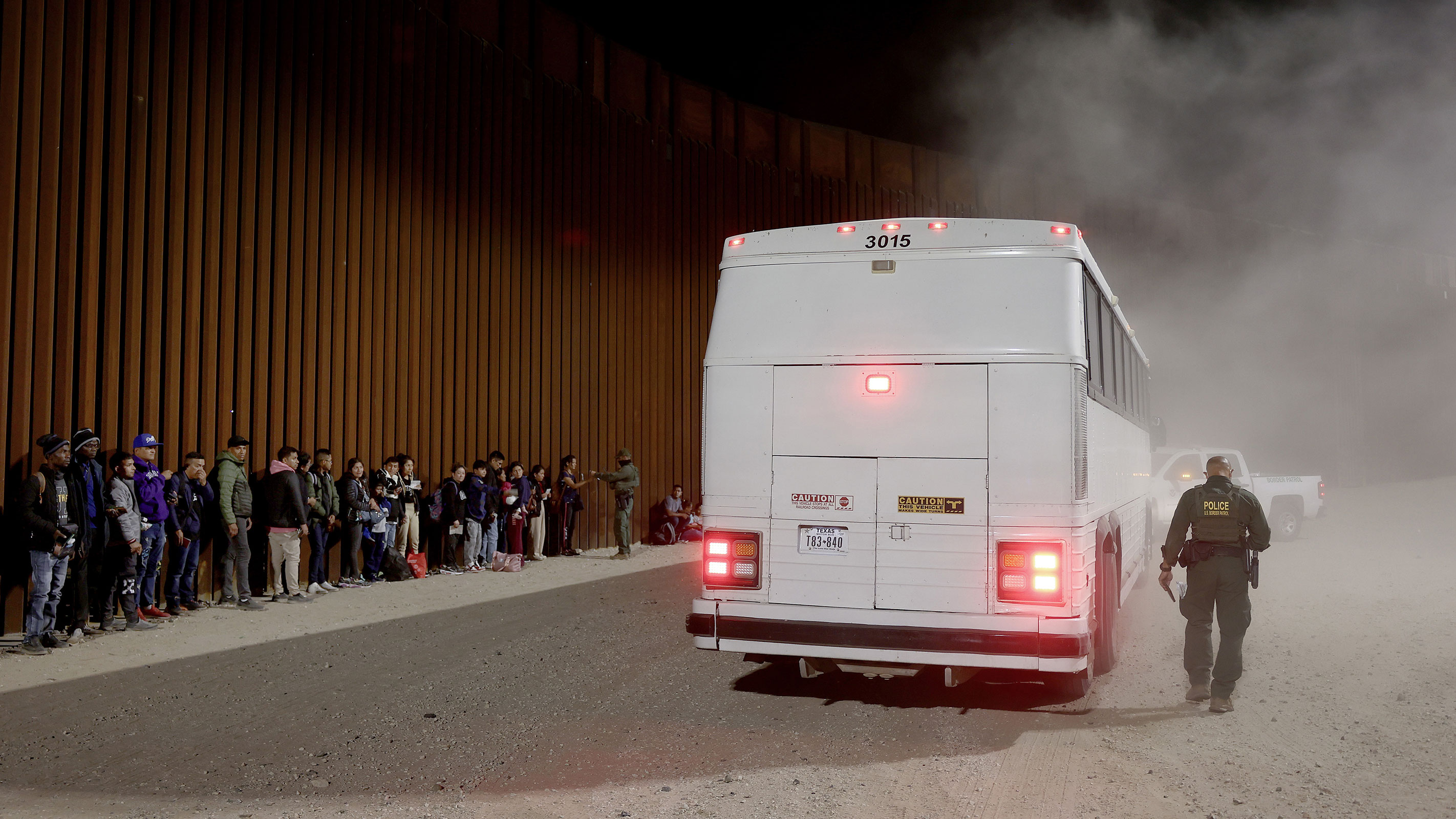 Immigrants seeking asylum in the United States are processed by Border Patrol agents after crossing into Arizona from Mexico on May 11.
