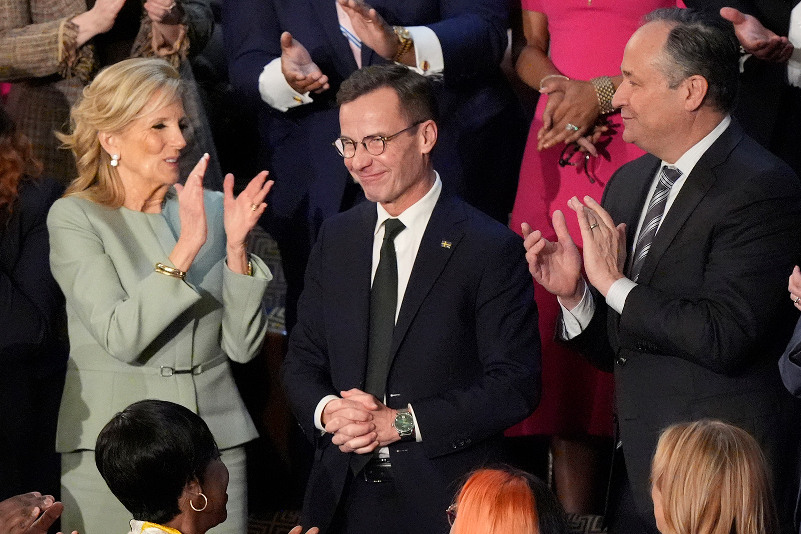 First lady Jill Biden and second gentleman Doug Emhoff applaud Sweden's Prime Minister Ulf Kristersson. Sweden officially joined NATO on Thursday.