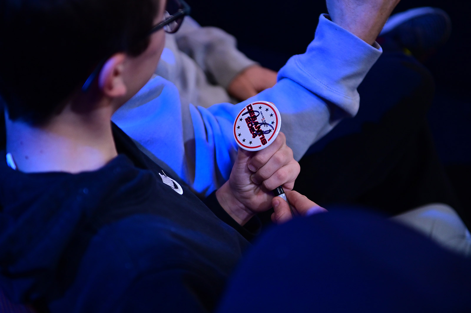 Max Korp, a 14-year-old from Southington, Connecticut, holds a campaign button that DeSantis signed during the town hall.