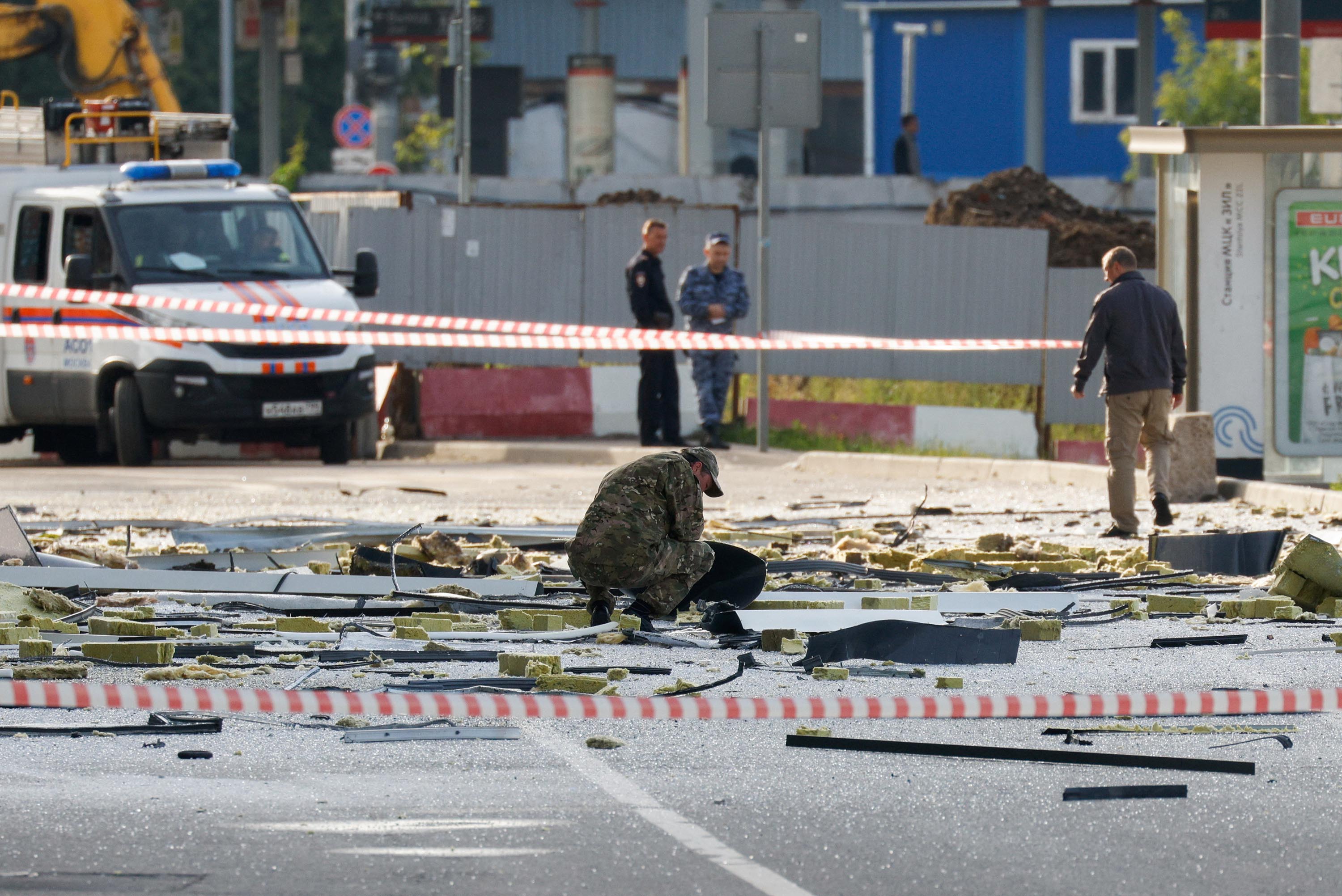 Members of the security services investigate the site of a damaged building following a reported drone attack in Moscow, Russia, on July 24.