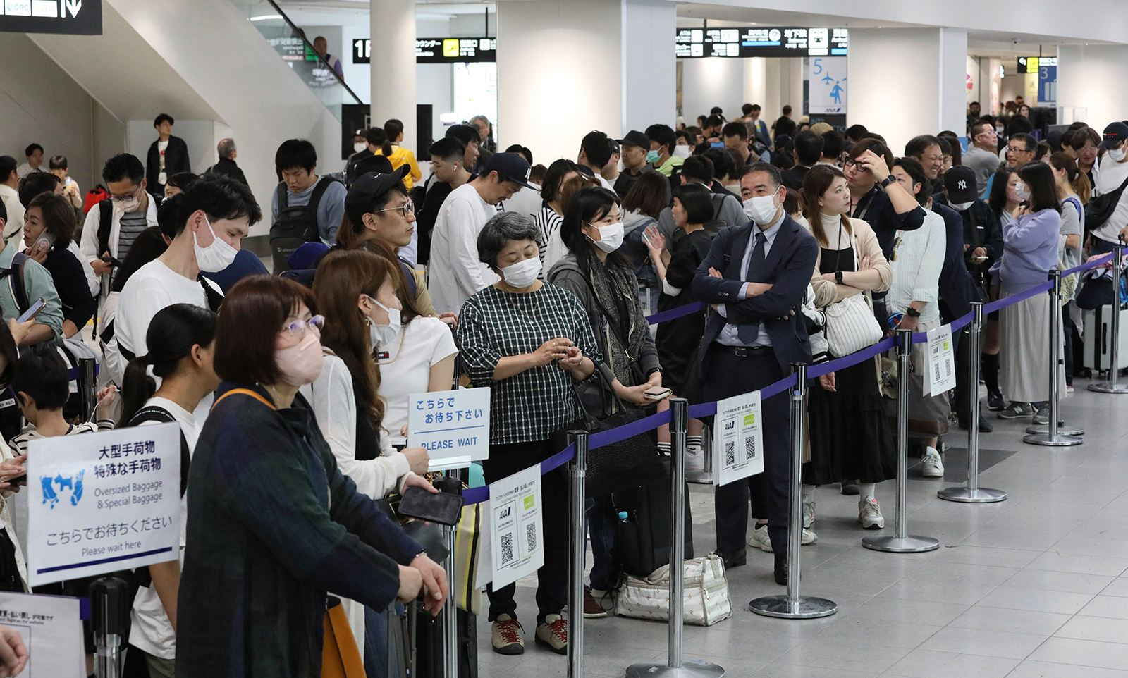 Fukuoka Airport was crowded with passengers after flight suspensions following a tsunami warning in Fukushima City on April 3.