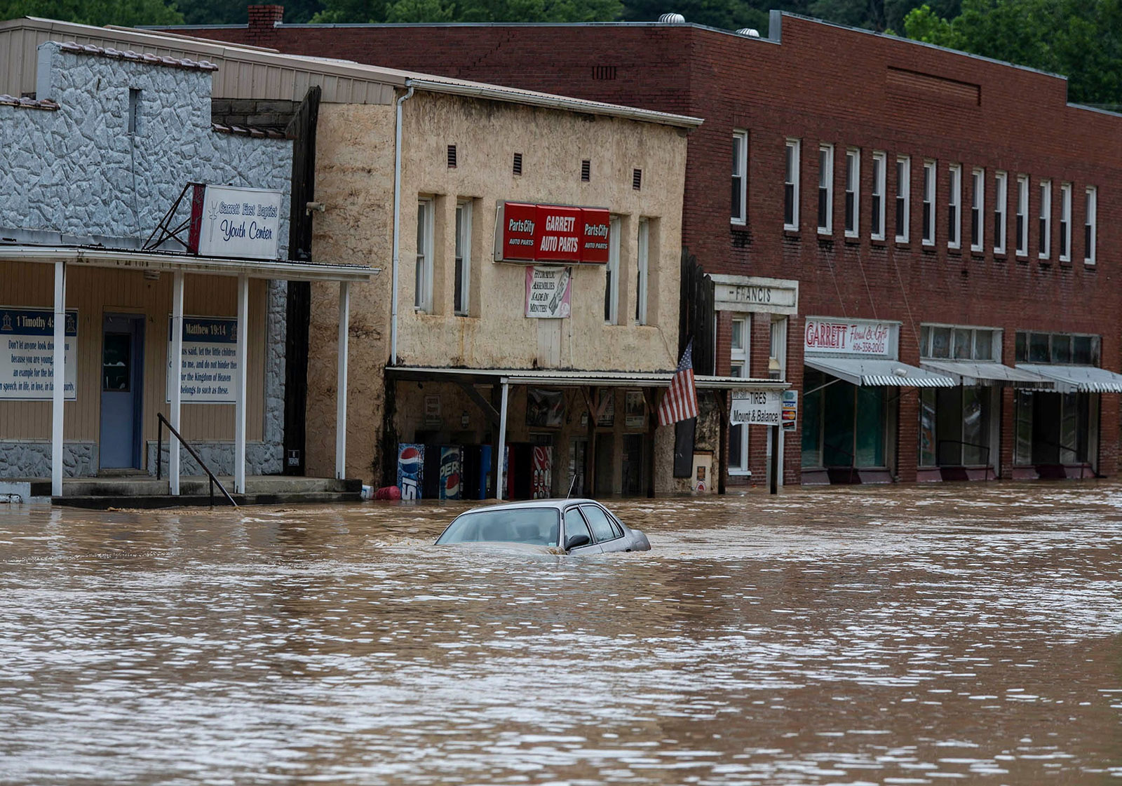 A car is submerged in floodwaters along Right Beaver Creek, following a day of heavy rain in Garrett, Kentucky, on July 28. 