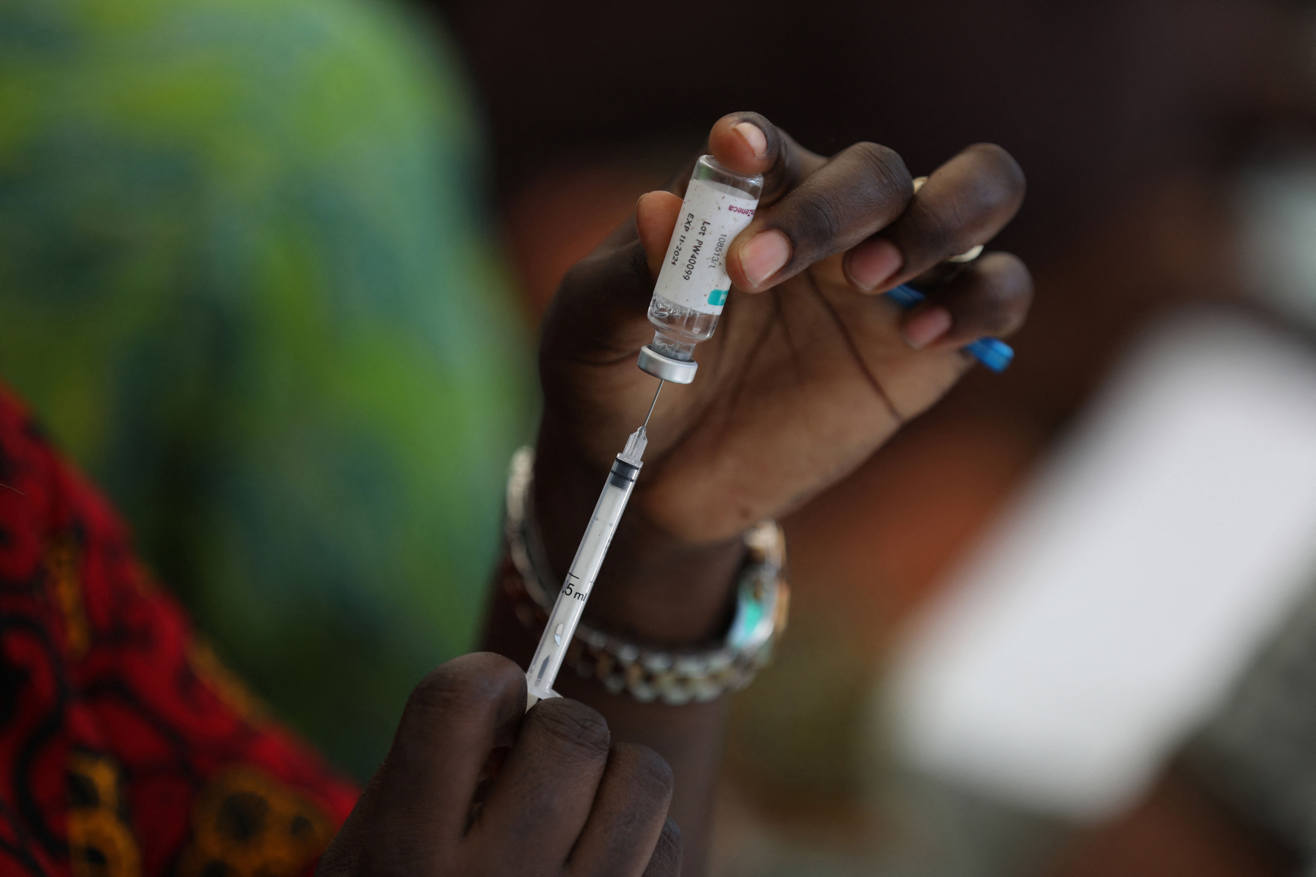 A health worker prepares to administer an AstraZeneca COVID-19 vaccine dose in Abuja, Nigeria, on November 19.