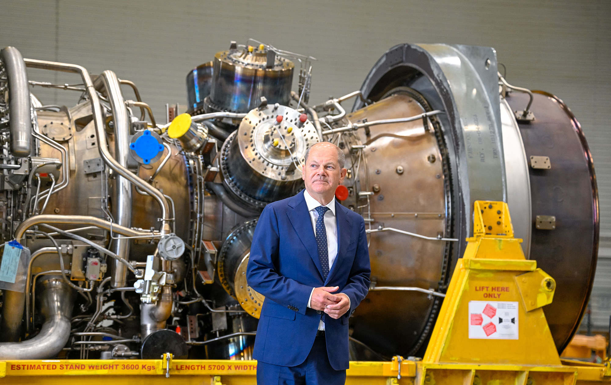 German Chancellor Olaf Scholz stands in front of a turbine of the Nord Stream 1 pipeline during a visit to the Siemens Energy plant in Muelheim, Germany, on August 3.