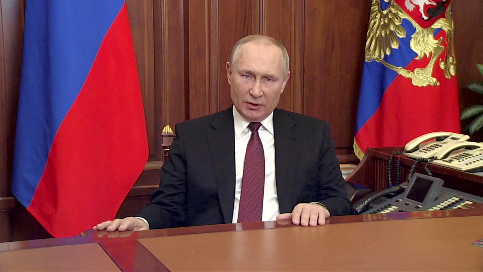 Russian President Vladimir Putin delivers a video address announcing the start of the military operation in eastern Ukraine, in Moscow, in a still image taken from video footage released February 24, 2022. 