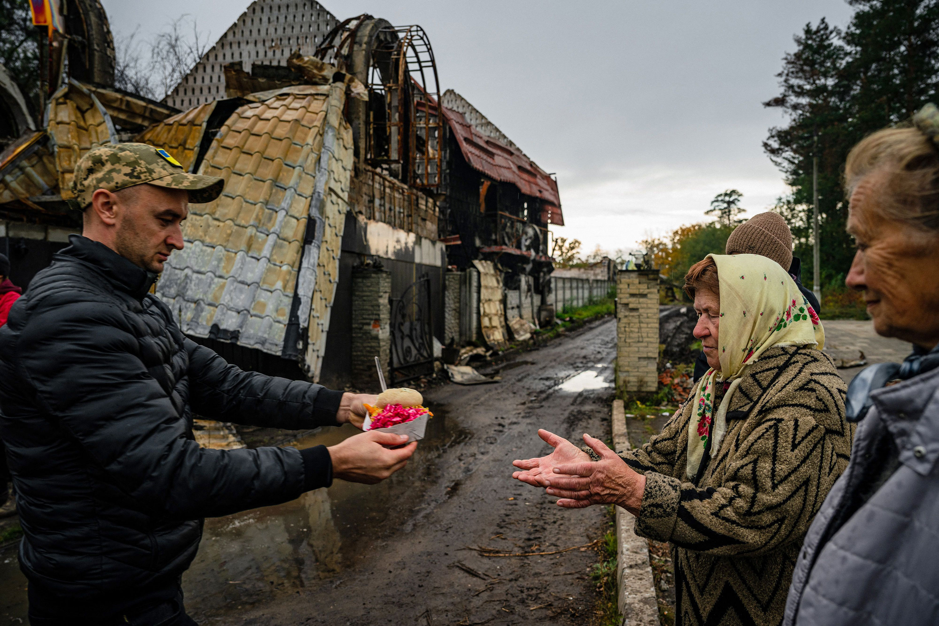 Women receive food and humanitarian aid in Svyatohirs'k, Ukraine, on Thursday.
