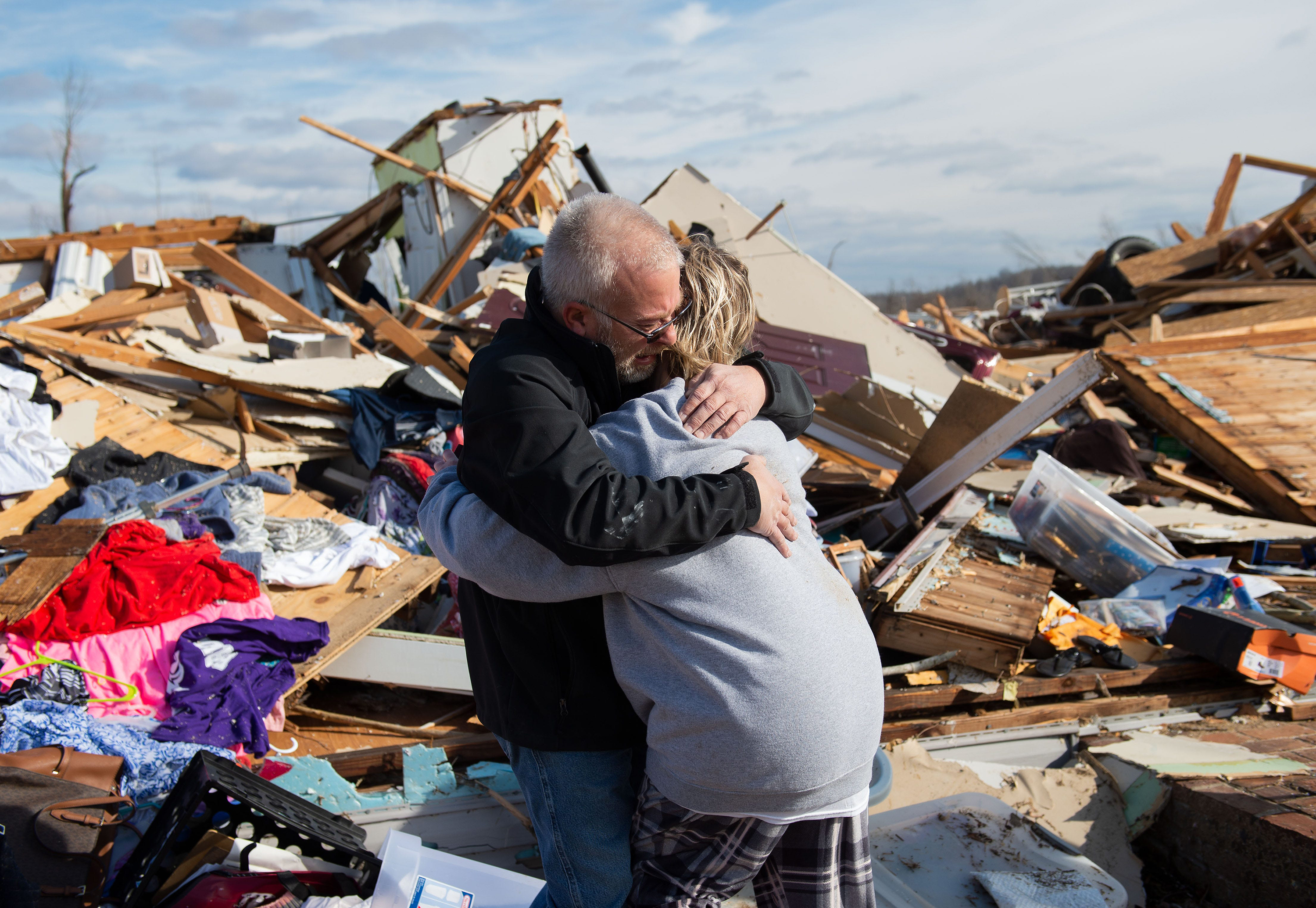 Mike Castle hugs his daughter Nikki Castle on Saturday, December 11, after the tornado in Dawson Springs, Kentucky. 