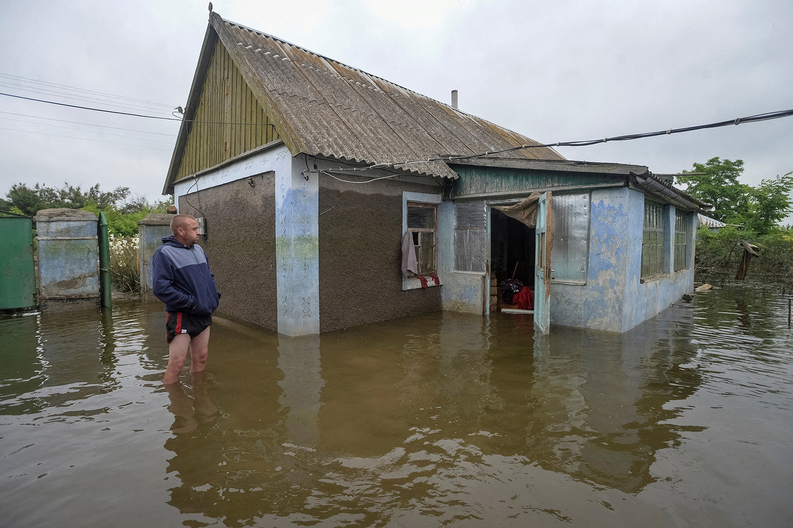 A local resident stands near a flooded house after the Nova Kakhovka dam breached, in Afanasiivka, Kherson region, Ukraine on June 12.