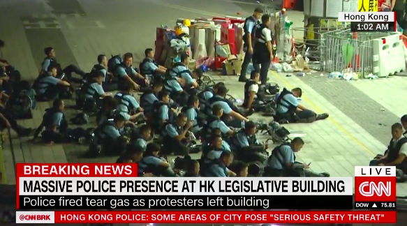Police sitting down outside Hong Kong's Legislative Council building after clearing protesters from the area.