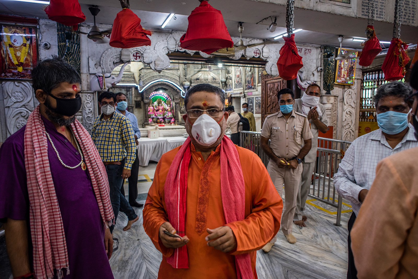 Indian Hindu priests and devotees walk inside Hunuman Mandir, on June 8, in Delhi.