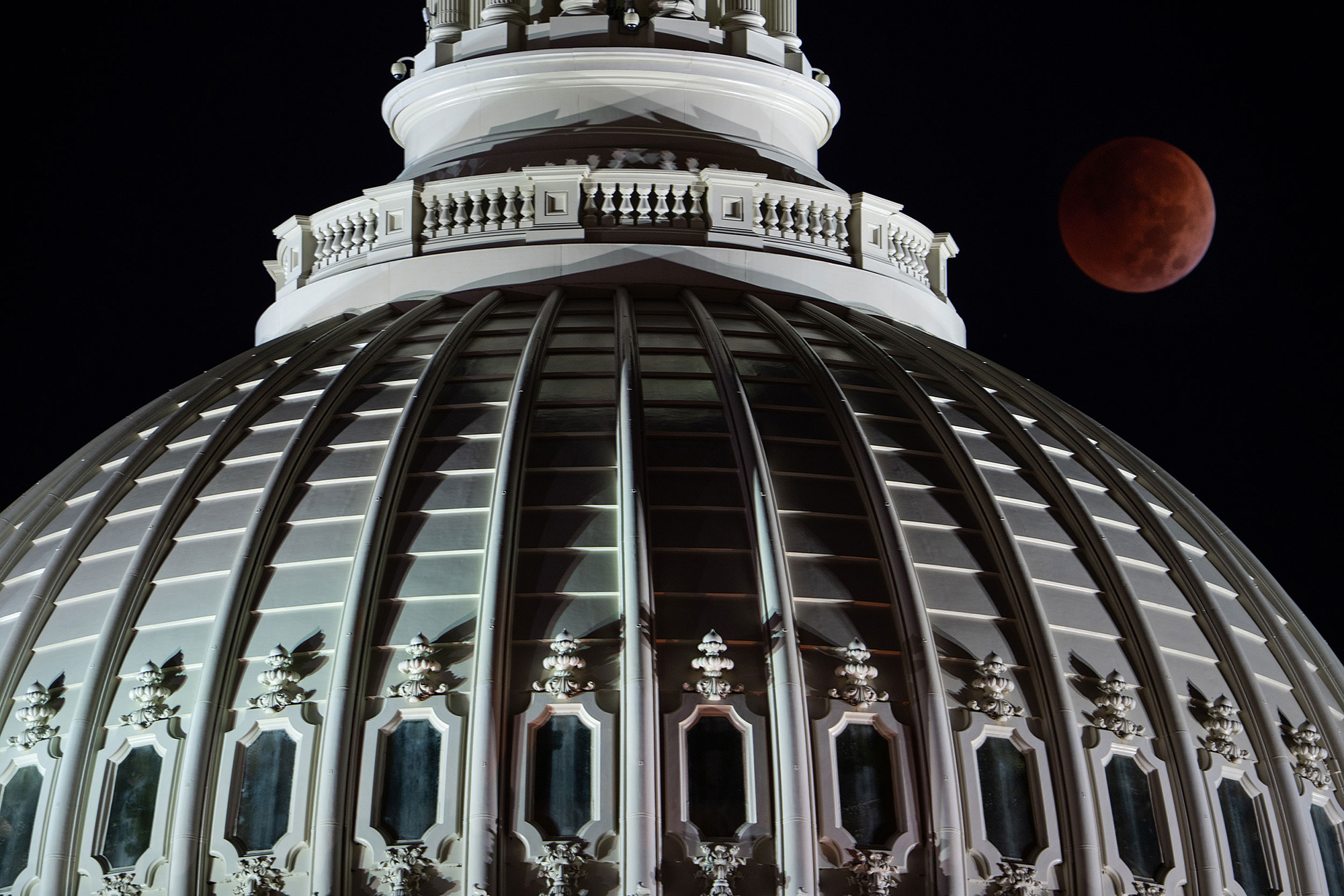 A blood moon lunar eclipse is seen behind the U.S. Capitol dome in Washington, D.C. on Election Day, Tuesday.